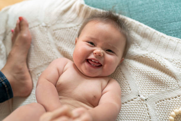 Happy baby boy is sitting on white background
