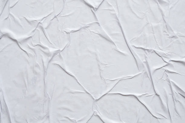 istock Blank white crumpled and creased paper poster texture background 1279718581