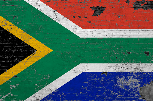 South Africa flag on grunge scratched concrete surface. National vintage background. Retro wall concept.