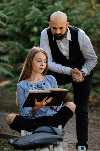 istock Two people studying and reading together in campus 1279719076