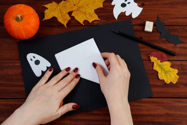 istock Halloween DIY. Step-by-step instructions for cutting a spider web from paper for the holiday. 1279726665