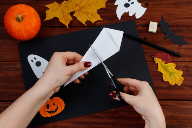 istock Halloween DIY. Step-by-step instructions for cutting a spider web from paper for the holiday. 1279726669
