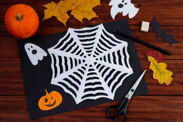 istock Halloween DIY crafts. Spider web cut from paper. Children's creativity. 1279726677