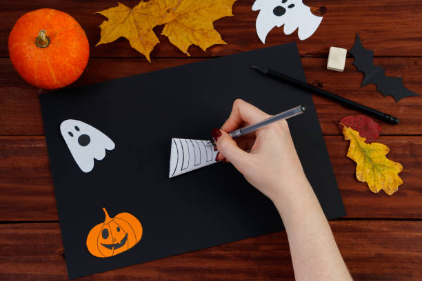 istock Halloween DIY. Step-by-step instructions for cutting a spider web from paper for the holiday. 1279726679