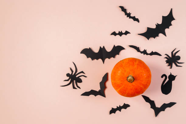 istock Happy Halloween. Bats and pumpkin on pink pastel background. 1279726705