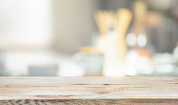 Wood table top on blur kitchen counter background Wood table top on blur kitchen counter background.For montage product display or design key visual layout. kitchen counter stock pictures, royalty-free photos & images