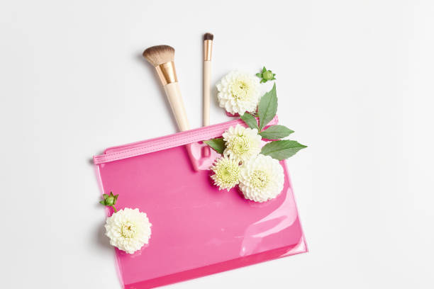 istock makeup concept. a pink cosmetic bag and makeup brushes. flat lay, top view 1279731490