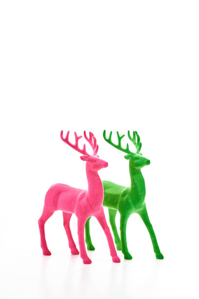 istock Christmas background with pink and green reindeer on white background 1279732419