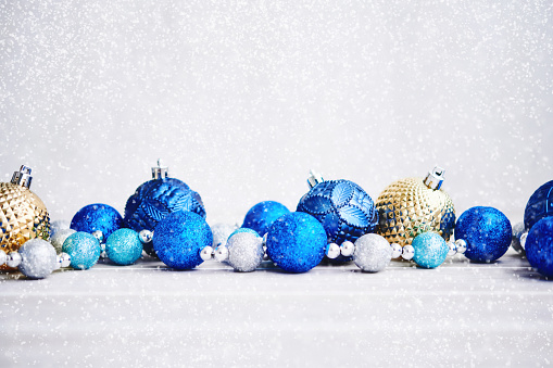 Christmas Background with Blue Silver and Gold Ornaments and Snow