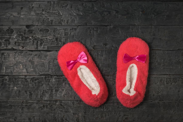 istock Home Slippers on a black wooden background. 1279736191
