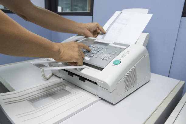 istock hand man are using a fax machine in the office, equipment for data transmission. 1279738052