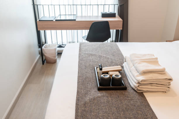 istock Set of hotel amenities (such as towels, shampoo, soap, toothbrush etc) on the bed. 1279738143
