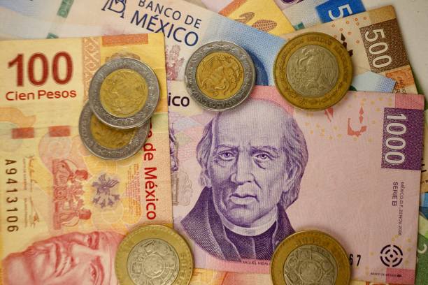 istock Many mexican pesos bills spread randomly over a flat surface 1279738858