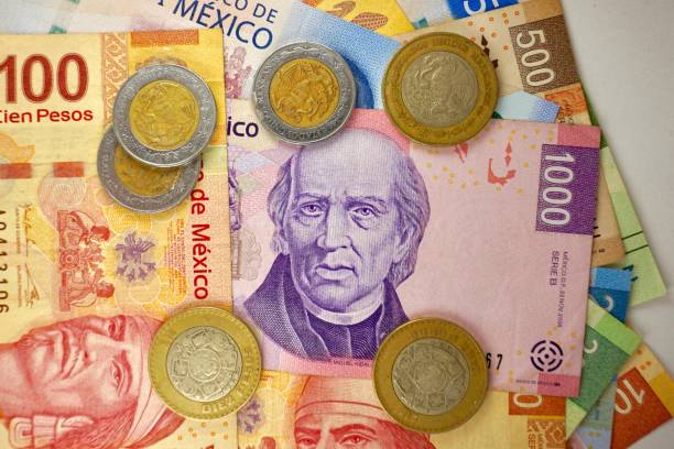 istock Many mexican pesos bills spread randomly over a flat surface 1279738895