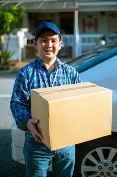 istock An Asian Delivery man bringing parcel 1279739682