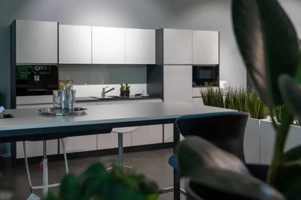 a white fitted kitchenette in an open-plan office