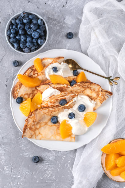 istock Pancakes with yoghurt, berries and peaches 1279739877