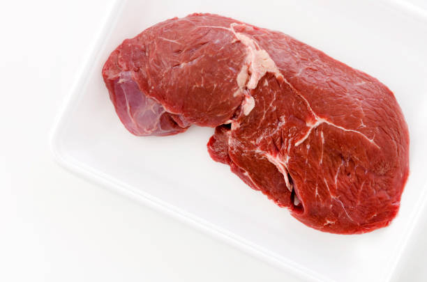 istock round steak on a foam tray on white background. 1279744953