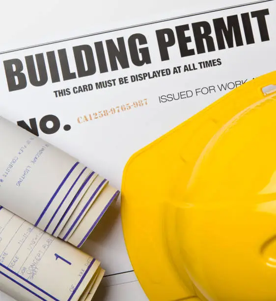 Photo of Building Permit - Construction Permit: with blueprints and hardhat