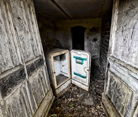 Abandoned refrigerator in an old cellar