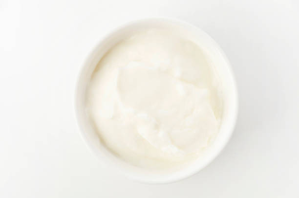istock Fresh greek yogurt in Ceramic white Ramequin on white background 1279746828