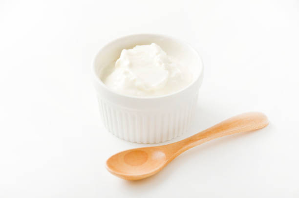 istock Fresh greek yogurt in Ceramic white Ramequin on white background 1279746838