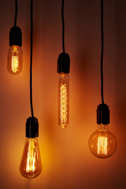 istock Set of a vintage light bulb on orange background. Glowing edison bulb 1279746961