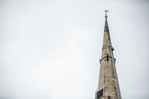 Church spire with a ladder installed for maintenance work by steeplejack