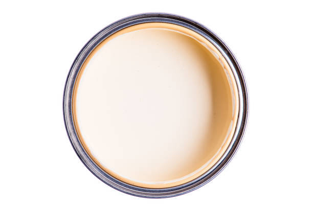 Opened paint can ivory color, top view isolated on white