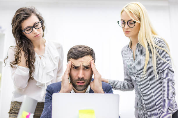 istock Photo of office manager and co-workers discussing questions. 1279748355