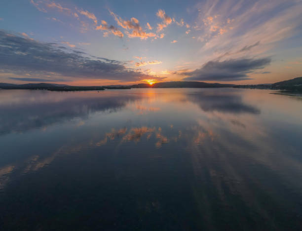 istock Sunrise waterscape with clouds and reflections 1279749303