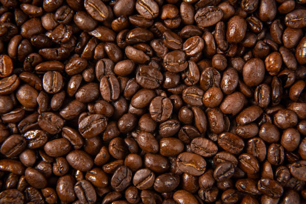 istock Freshly roasted coffee beans background. close up. 1279752123