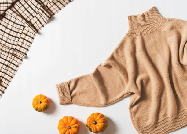 istock Beige cozy sweater fashion flat lay on white textile background 1279753031