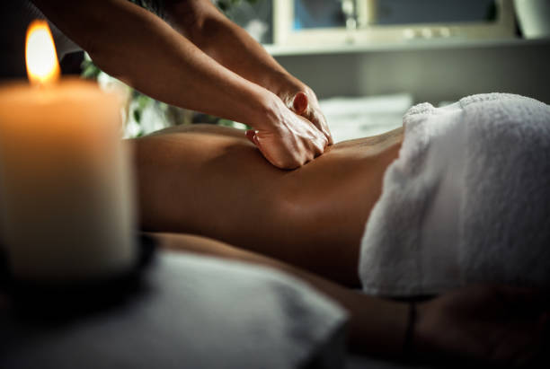 스파에서 치료 마사지를 즐기는 젊은 여성 - body massage 뉴스 사진 이미지