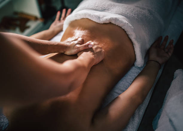 istock Young woman enjoying therapeutic  massage in spa 1279755747