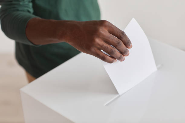 hombre con papeleta - urna de voto fotografías e imágenes de stock