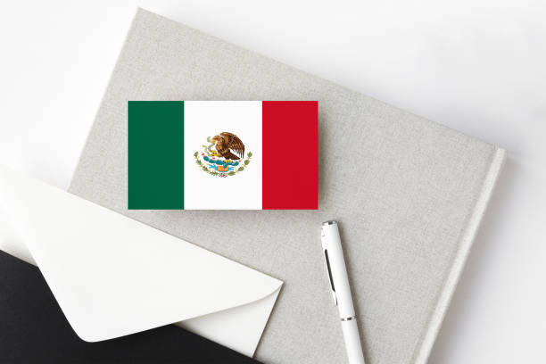 istock Mexico flag on minimalist letter background. National invitation envelope with white pen and notebook. Communication concept. 1279756178