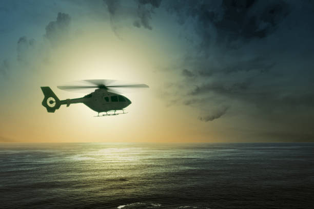 istock Helicopter flying in the air above the ocean 1279757324