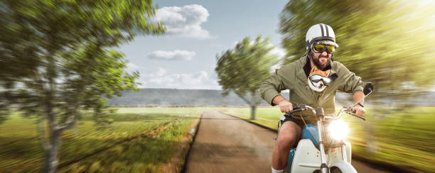 istock Funny man with his dog riding a motorcycle at top speed 1279757353