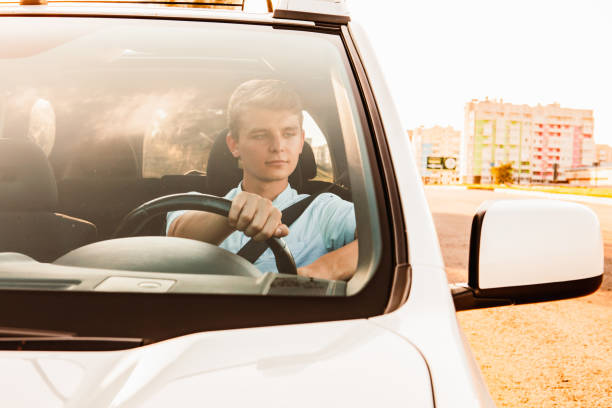 istock young handsome confident man driving car 1279758880