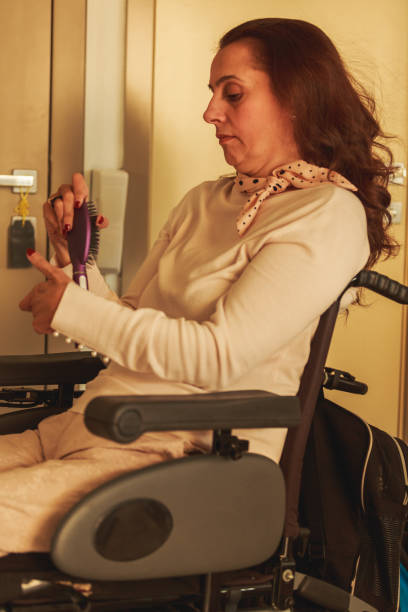 istock Woman in wheelchair using a comb 1279760456