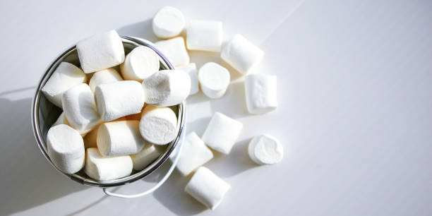 istock White mini marshmallows background close-up texture. Food background. Copy space. White metal bucket 1279760591