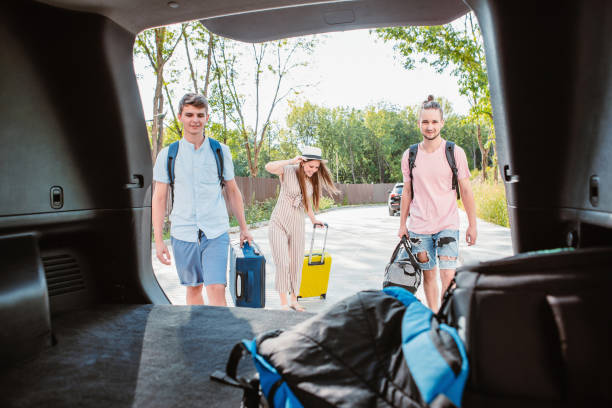 istock friends load car trunk with baggage 1279760747