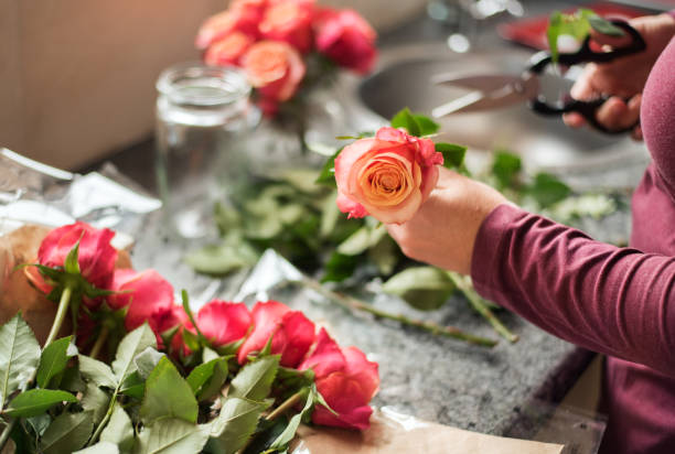 istock Woman preparing flowers for vase 1279760753
