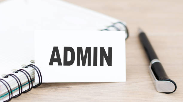 istock Admin inscription on a white card next to a notebook and a pen on the table 1279762132