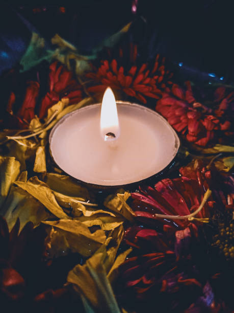istock Tealight candle surrounded by flowers in water. 1279762476