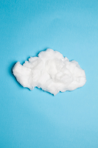 White cloud made of cotton on blue background.