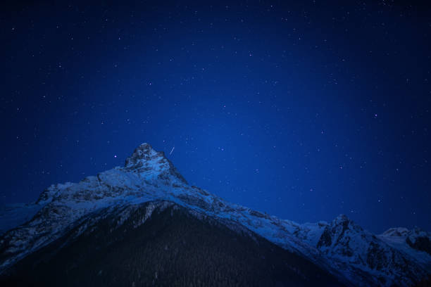 istock Paraglider above the mountains 1279765107