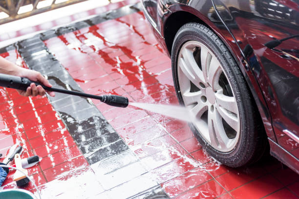 istock Man cleaning the car wheels 1279766642