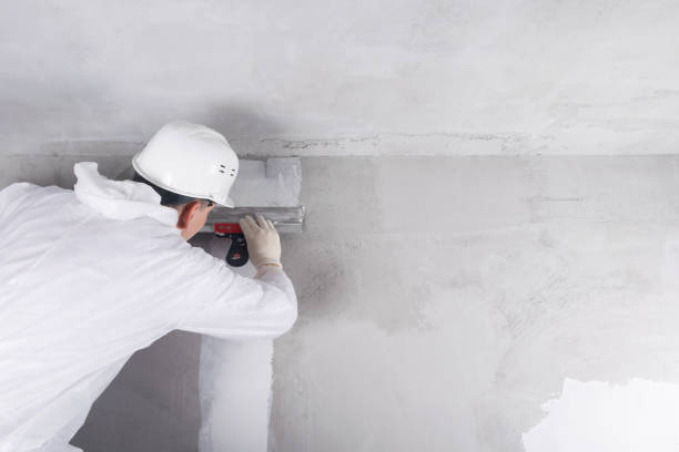 istock a worker in a helmet repairs walls indoors 1279768204